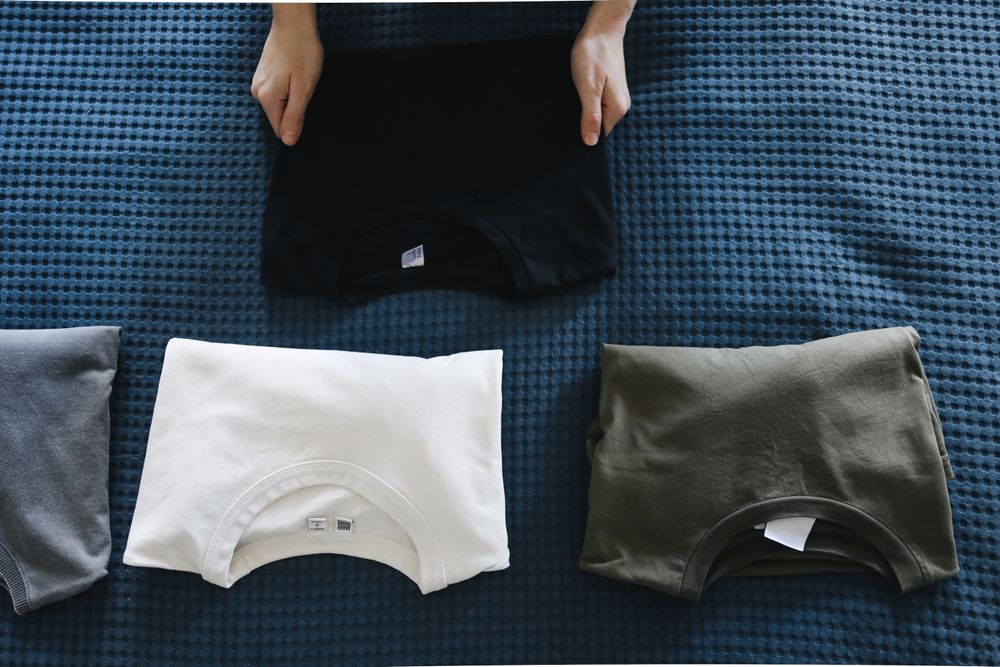 Stacked blank t-shirts ready for custom apparel production.